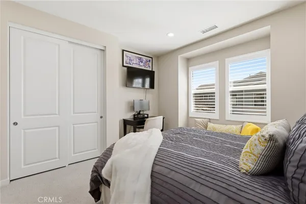 a spacious bathroom with a tub sink and mirror