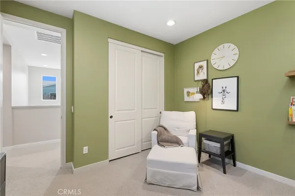 a dining room with furniture and a large window