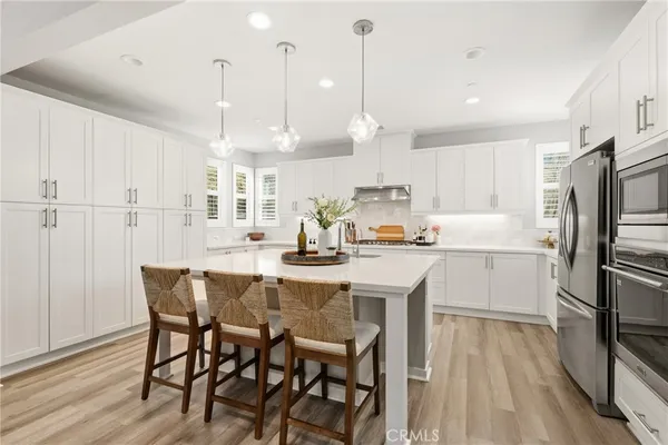 a kitchen with kitchen island a sink appliances and cabinets