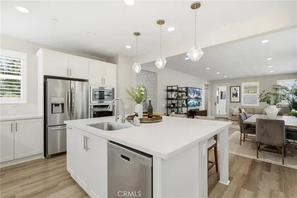 a kitchen with stainless steel appliances white cabinets and a stove