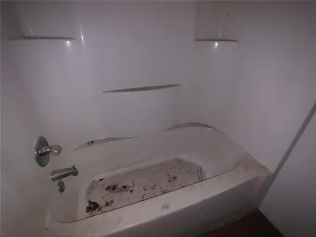 a toilet sitting in a bathroom next to a sink