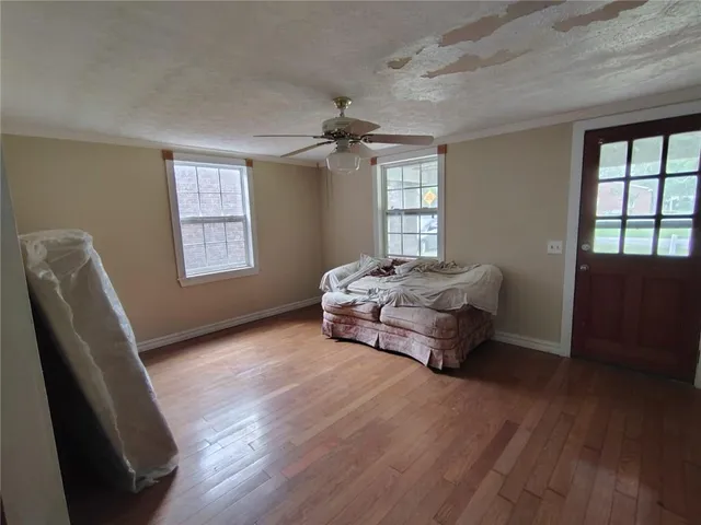 a room with a bed and wooden floor