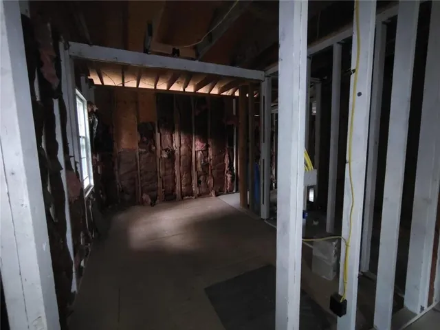 a view of a hallway with wooden floor and entryway