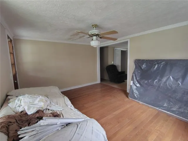 a bedroom with a bed and a ceiling fan