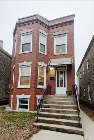 a front view of a residential apartment building with a yard