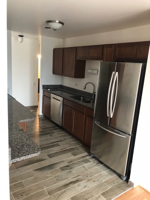 425 Walnut Creek Road, Unit 1608 Lisle, IL 60532 - Photo 3 of 13 a kitchen with stainless steel appliances granite countertop a refrigerator and a sink