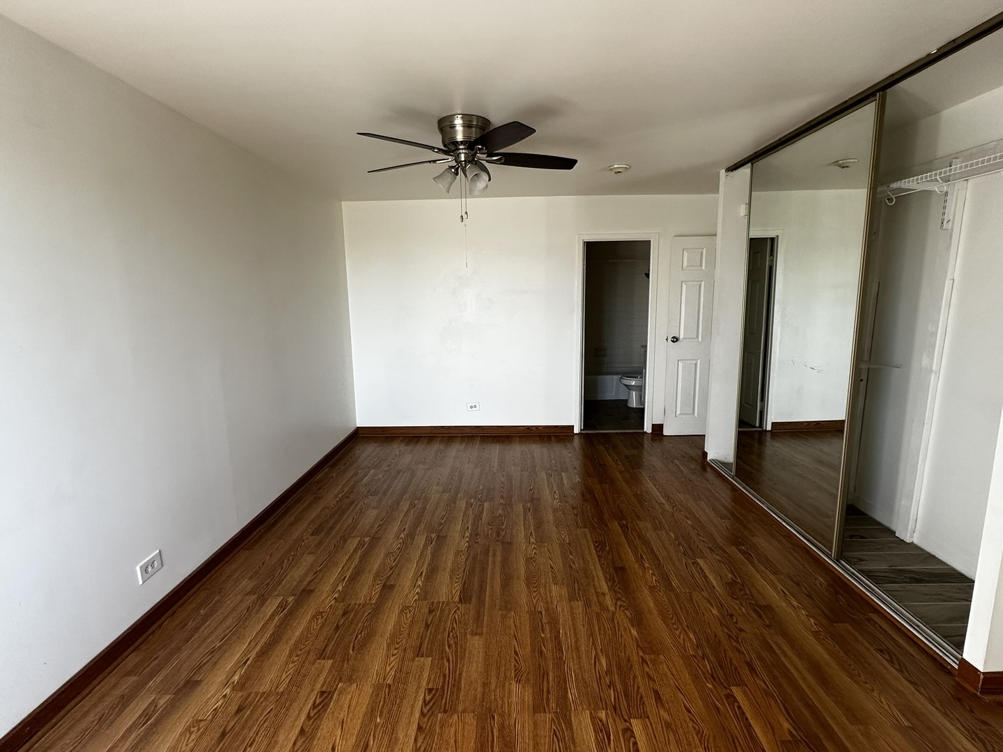 425 Walnut Creek Road, Unit 1608 Lisle, IL 60532 - Photo 10 of 13 a view of a room with wooden floor and a ceiling fan
