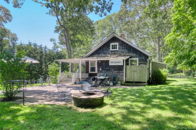 a view of a house with backyard sitting area and garden