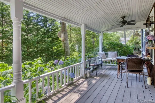 a view of a porch with furniture and wooden floor