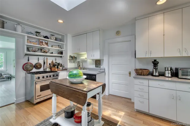 a kitchen with a stove and white cabinets