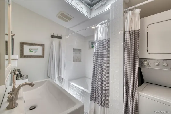 a bathroom with a tub sink and toilet