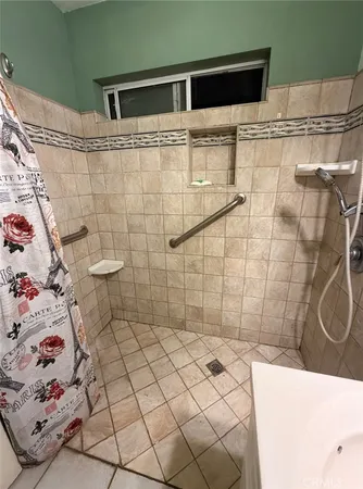 a bathroom with a shower and a sink