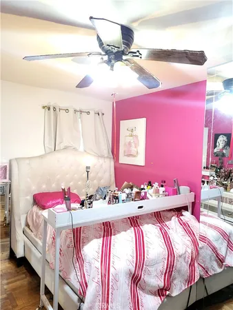 a bedroom with a bed and a chandelier