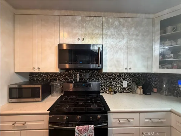 a kitchen with a stove and a microwave