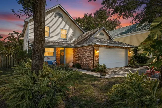 a view of a house with a small yard and floor to ceiling window