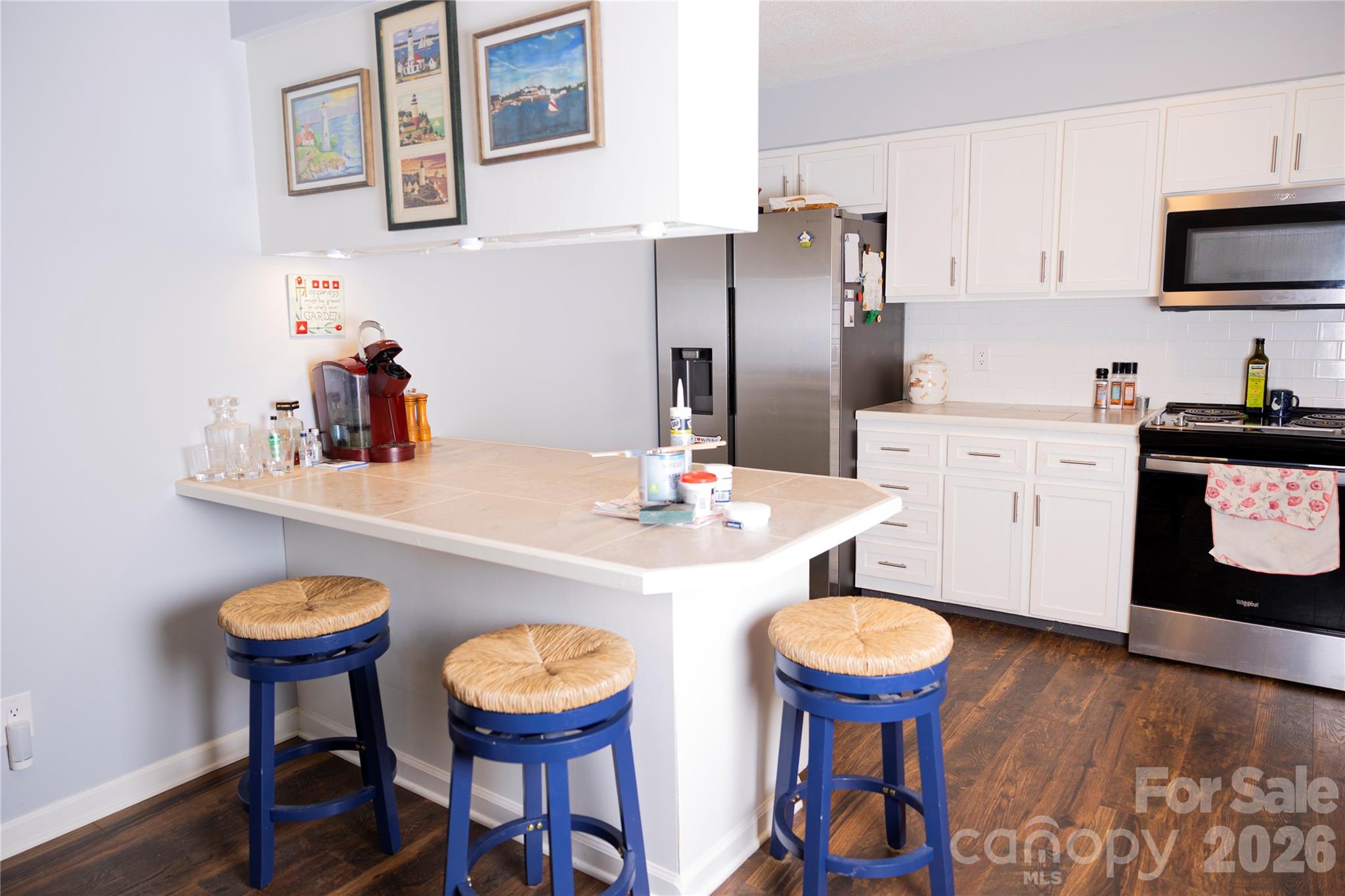 57 Gribble Road Franklin, NC 28734 - Photo 12 of 39 a kitchen with stainless steel appliances a dining table and chairs