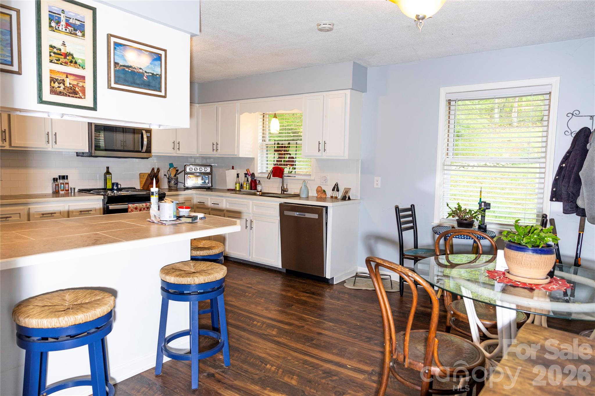 57 Gribble Road Franklin, NC 28734 - Photo 13 of 39 a kitchen with stainless steel appliances a dining table chairs and a refrigerator