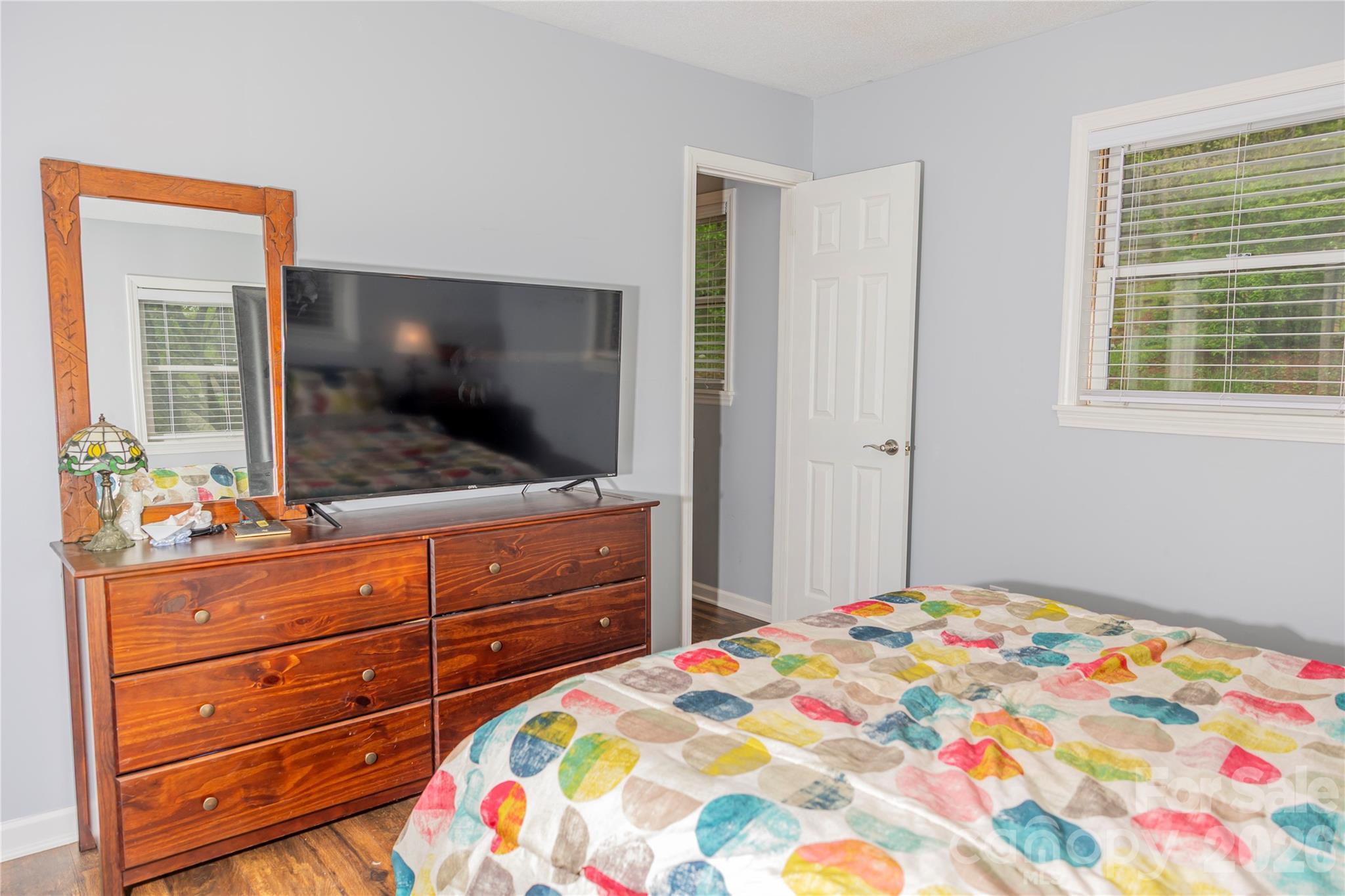 57 Gribble Road Franklin, NC 28734 - Photo 28 of 39 a bedroom with a bed and a flat screen tv in a dresser