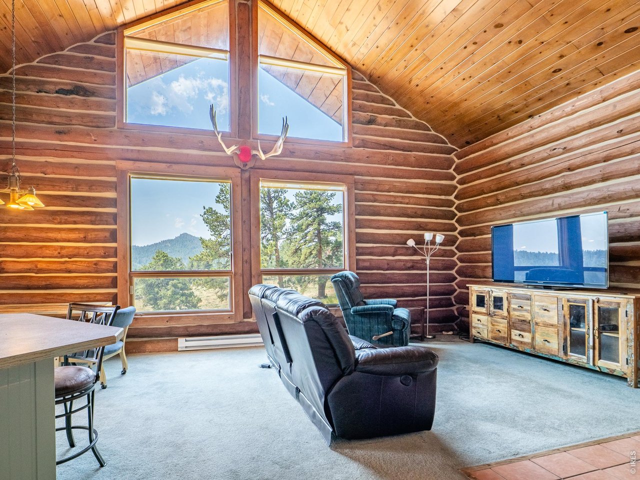 296 Caddo Road Red Feather Lakes, CO 80545 - Photo 12 of 50 Two levels of windows in the great room.