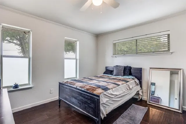 a bed sitting in a bedroom next to a window