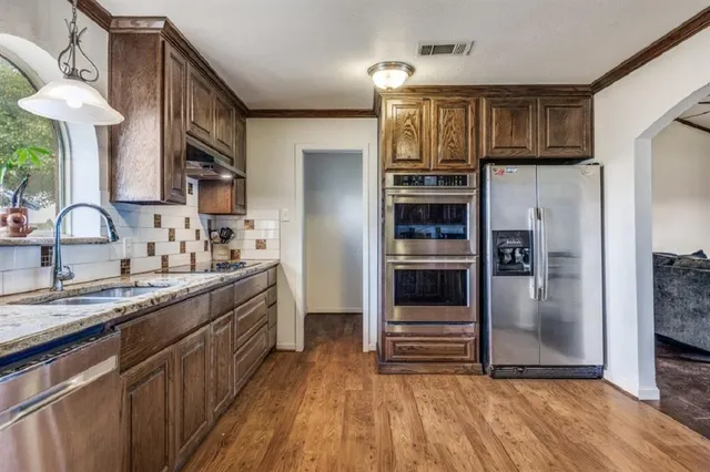 a kitchen with stainless steel appliances a refrigerator and a sink