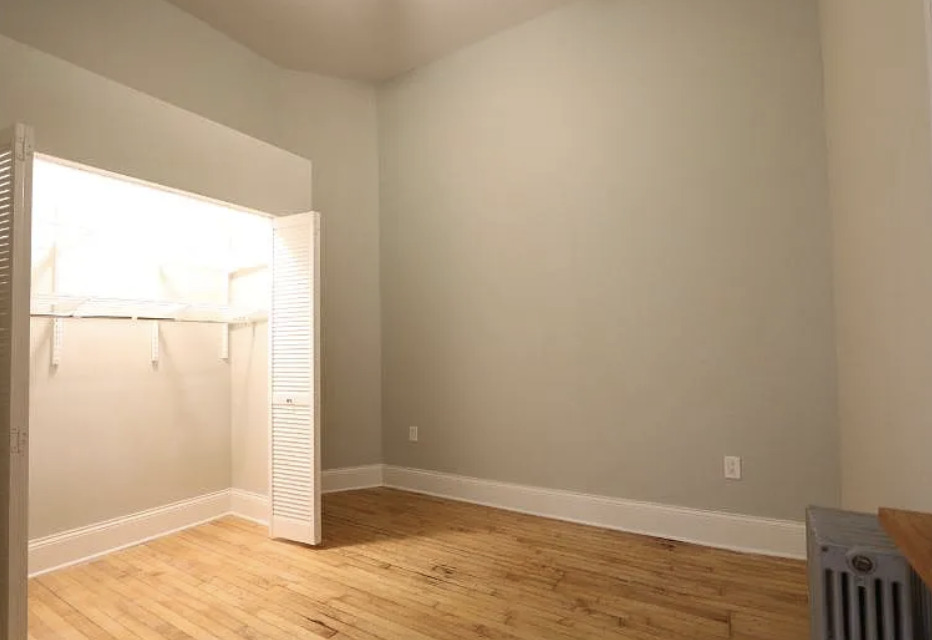 1316 West Erie Street, Unit 1E Chicago, IL 60642 - Photo 11 of 12 an empty room with wooden floor and windows