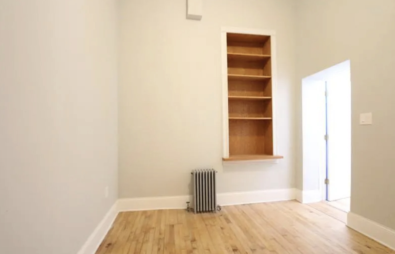 1316 West Erie Street, Unit 1E Chicago, IL 60642 - Photo 12 of 12 a view of a room with wooden floor and a window