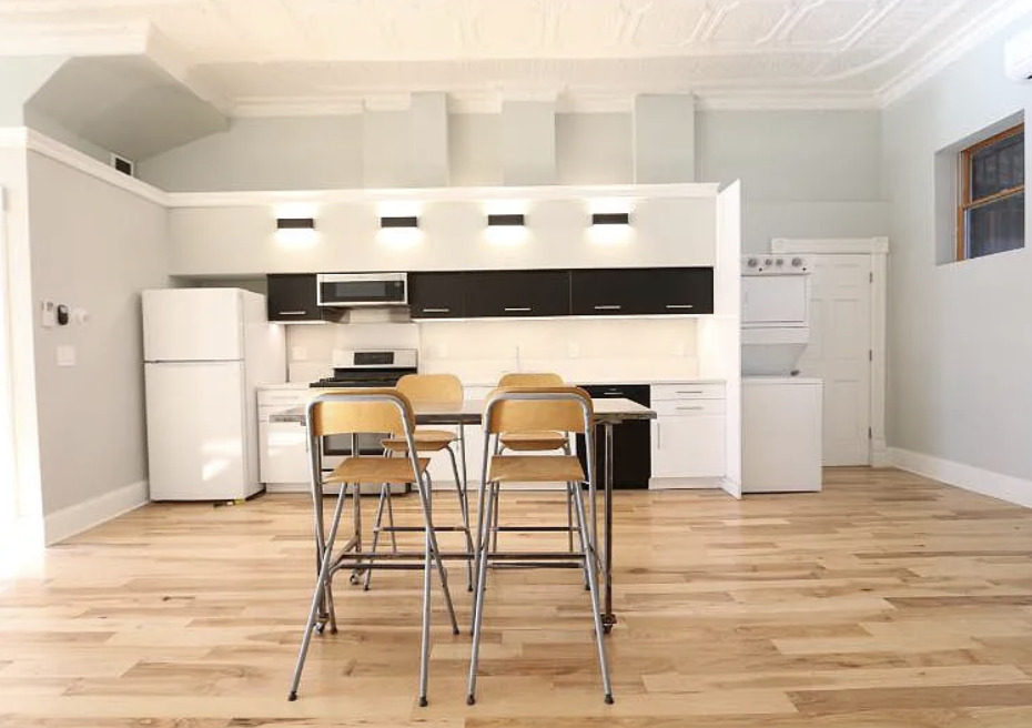 1316 West Erie Street, Unit 1E Chicago, IL 60642 - Photo 8 of 12 a living room with a table and chairs