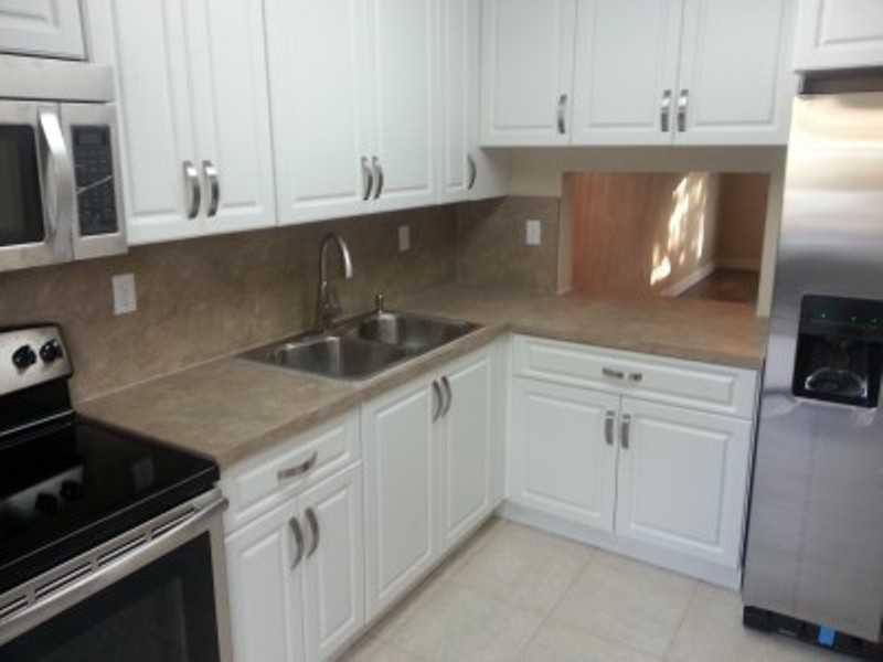 6345 Southwest 138th Court, Unit 102 Miami, FL 33183 - Photo 3 of 6 a kitchen with white cabinets and a sink