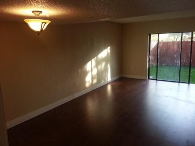 6345 Southwest 138th Court, Unit 102 Miami, FL 33183 - Photo 4 of 6 a view of empty room with wooden floor and fan