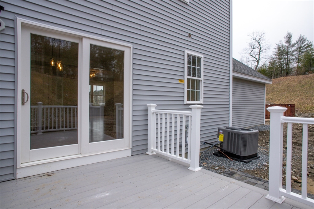 11 Ayer Road Littleton, MA 01460 - Photo 3 of 42 a view of a house with a small yard and wooden fence