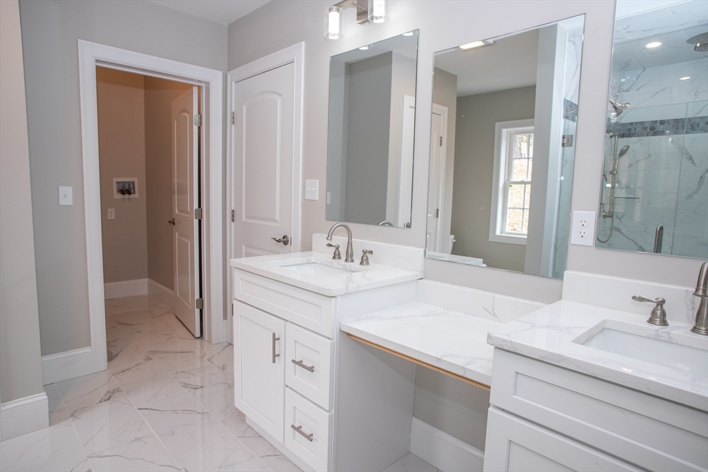 11 Ayer Road Littleton, MA 01460 - Photo 35 of 42 a bathroom with a granite countertop sink and a mirror
