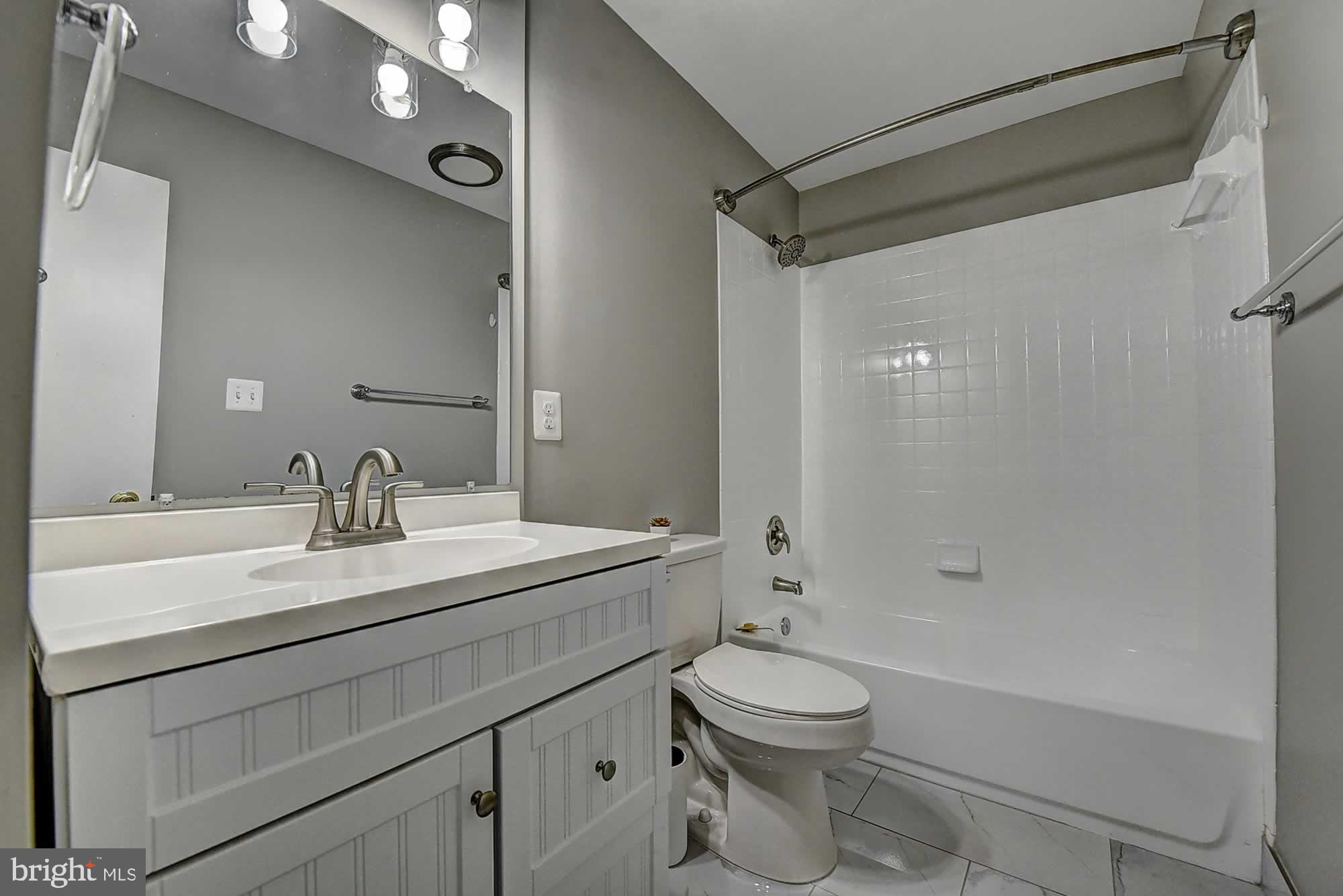 2226 Gunsmith Square Reston, VA 20191 - Photo 33 of 35 a bathroom with a sink a toilet and shower