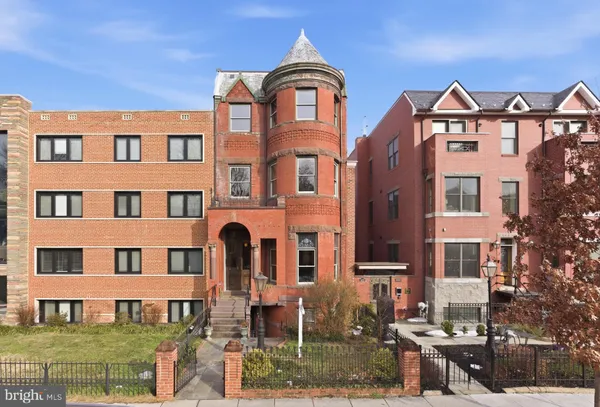 a front view of a residential apartment building with a yard