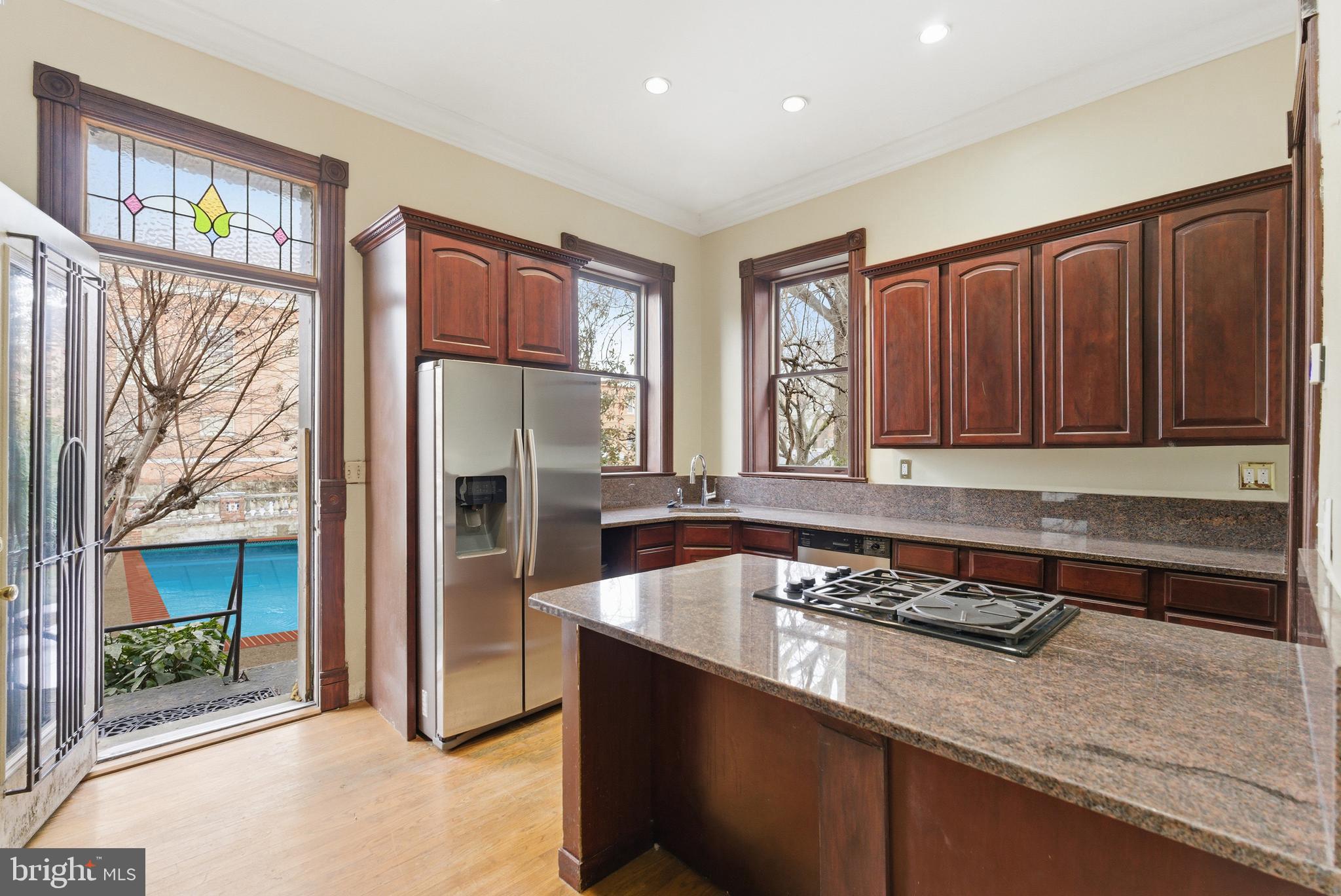 1827 13th Street Northwest Washington, DC 20009 - Photo 15 of 23 a kitchen with stainless steel appliances granite countertop a refrigerator and a sink
