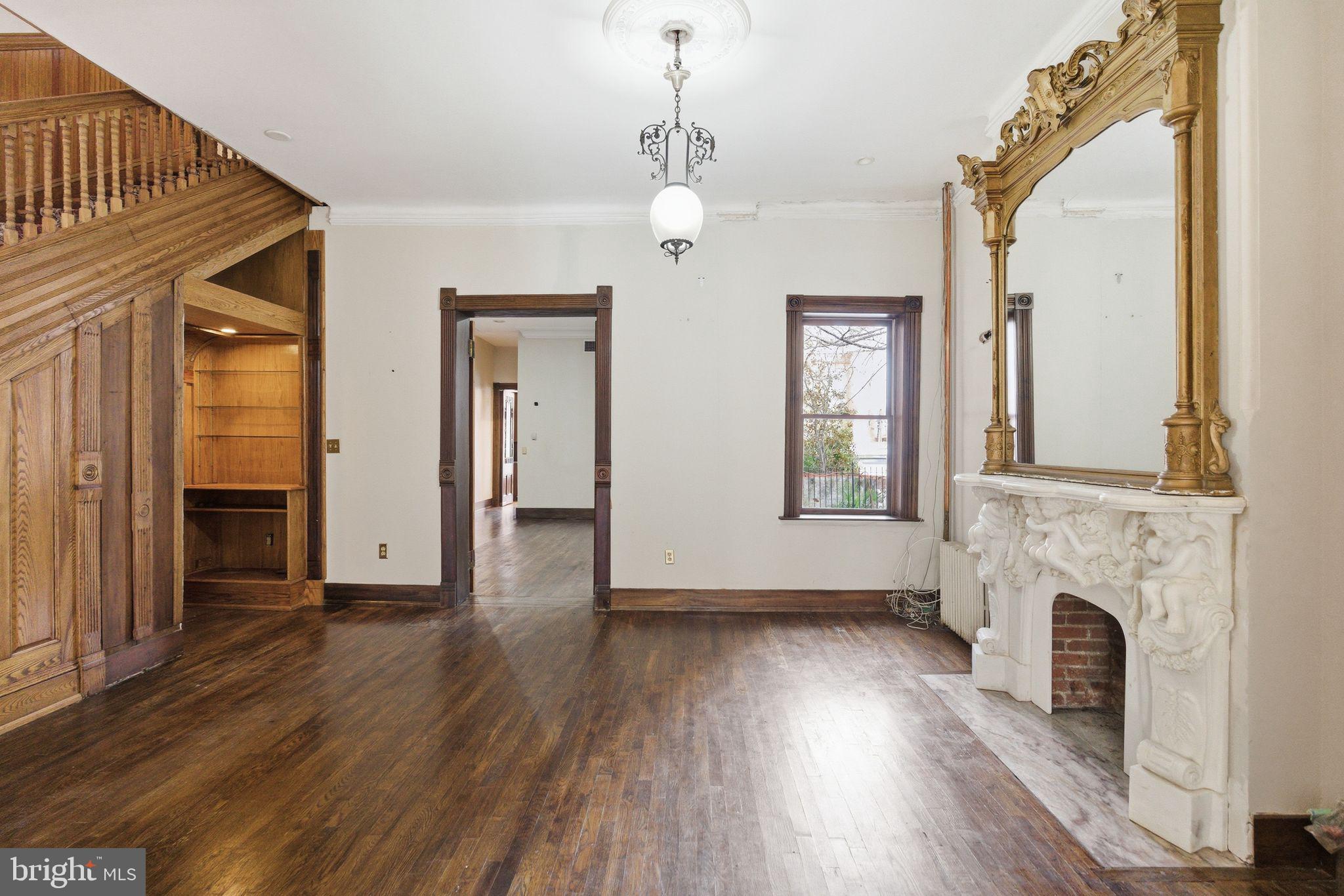 1827 13th Street Northwest Washington, DC 20009 - Photo 16 of 23 wooden floor fireplace and windows in an empty room