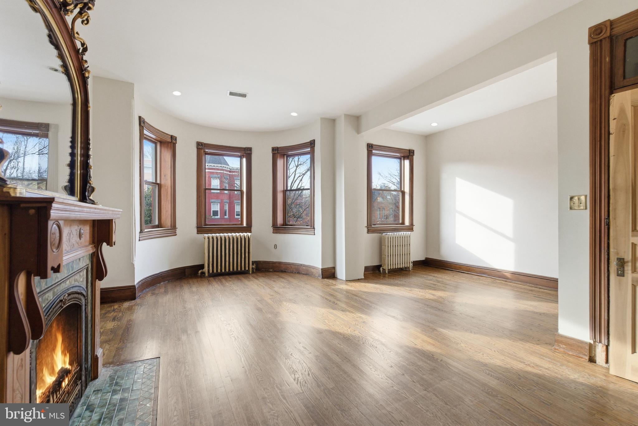 1827 13th Street Northwest Washington, DC 20009 - Photo 18 of 23 a view of a livingroom with a fireplace window and wooden floor