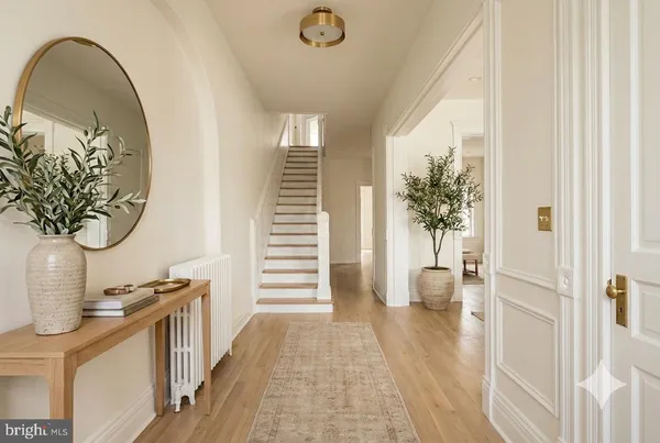 a view of an entryway with wooden floor