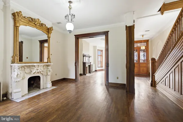 a view of a livingroom with wooden floor and a fireplace