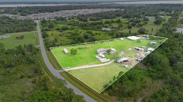 an aerial view of a golf course with chairs