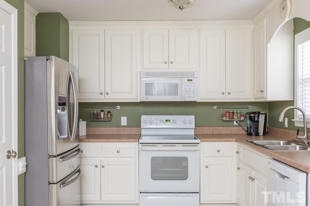 552 Axum Road Willow Spring, NC 27592 - Photo 5 of 25 Lots of cabinets will keep your kitchen organized!
