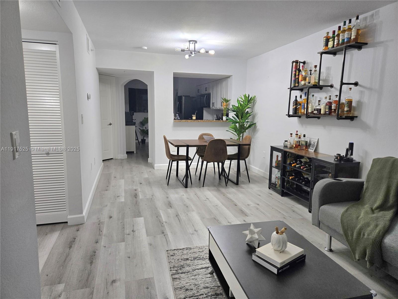 22311 Southwest 88th Place, Unit 2044 Cutler Bay, FL 33190 - Photo 4 of 7 a living room with furniture and wooden floor