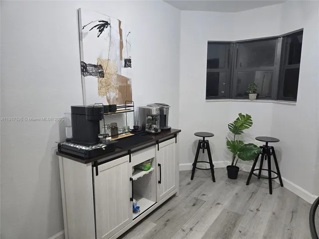 a view of a workspace with furniture and wooden floor