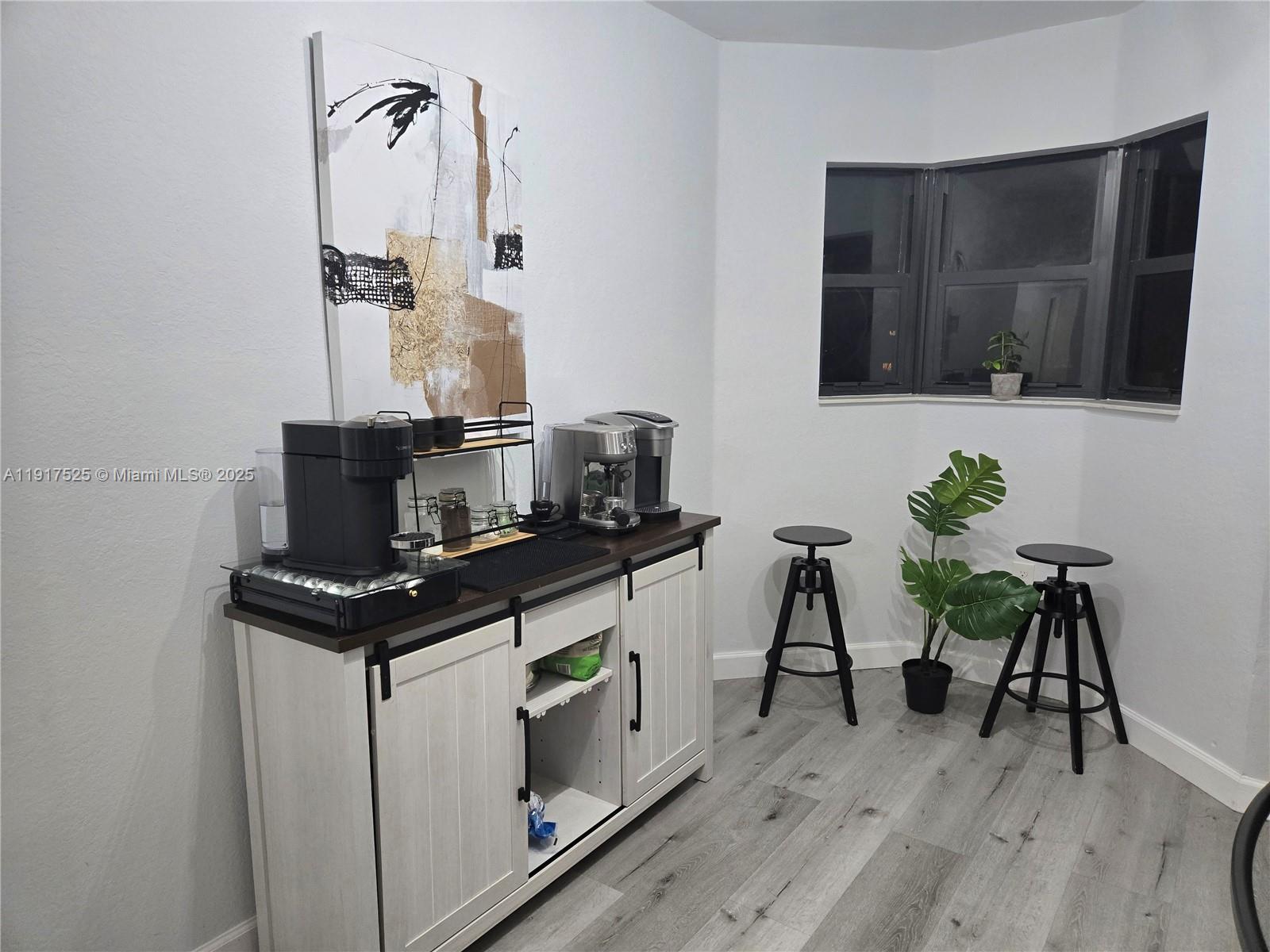 22311 Southwest 88th Place, Unit 2044 Cutler Bay, FL 33190 - Photo 6 of 7 a view of a workspace with furniture and wooden floor