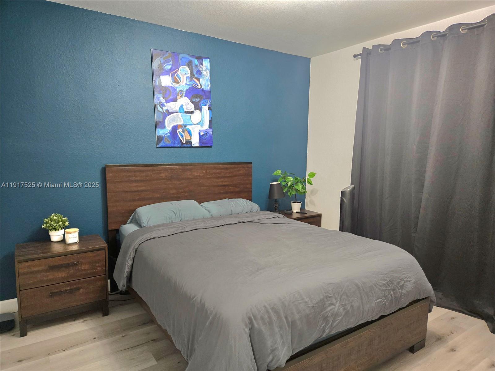 22311 Southwest 88th Place, Unit 2044 Cutler Bay, FL 33190 - Photo 7 of 7 a bedroom with a bed and wooden floor