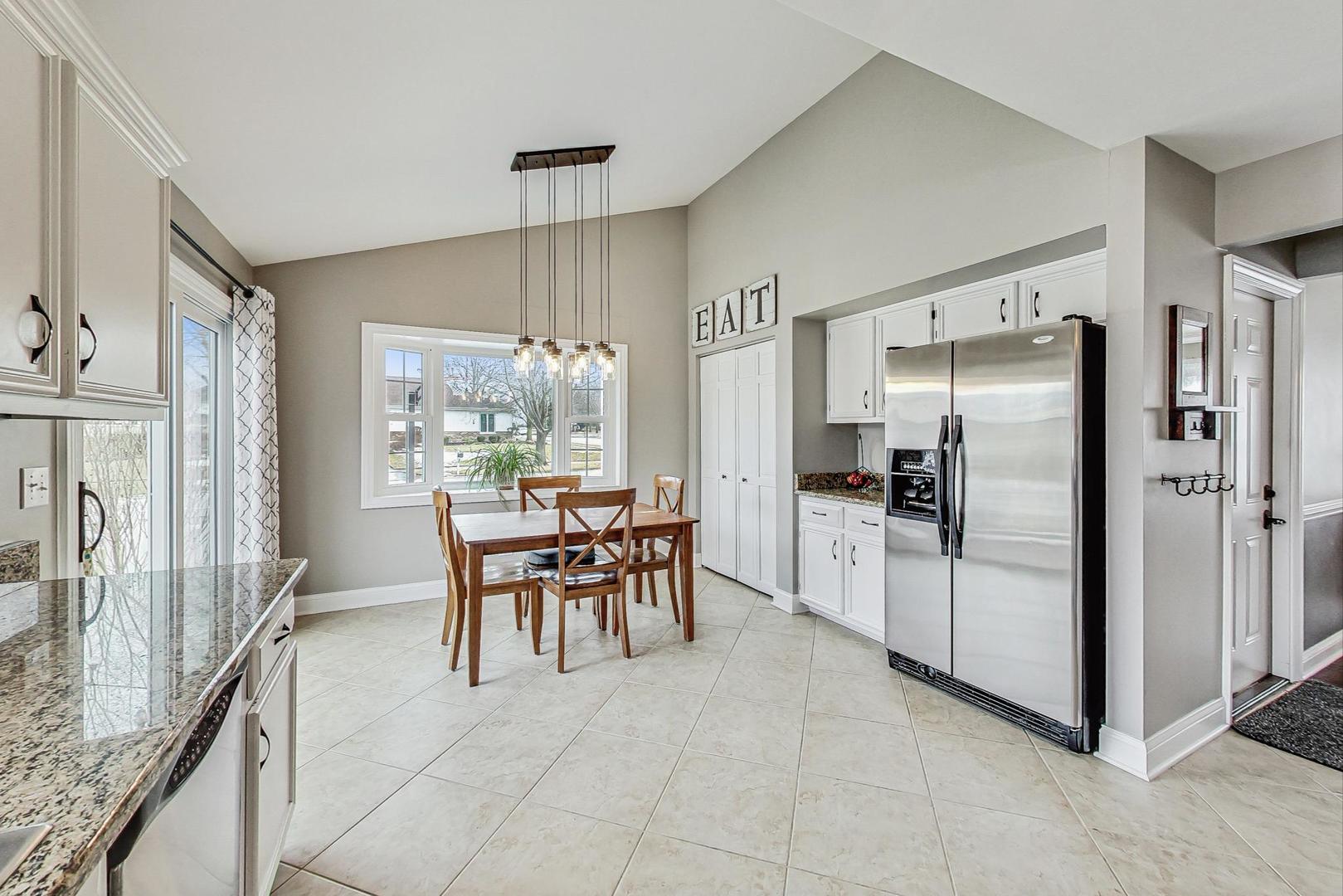 1345 East Bailey Road Naperville, IL 60565 - Photo 11 of 49 a dining area with stainless steel appliances granite countertop a refrigerator and a stove top oven