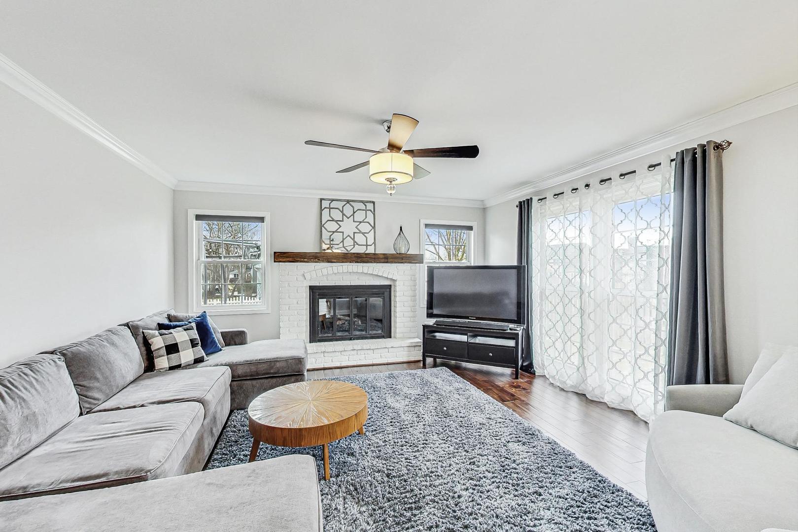 1345 East Bailey Road Naperville, IL 60565 - Photo 13 of 49 a living room with furniture and a fireplace