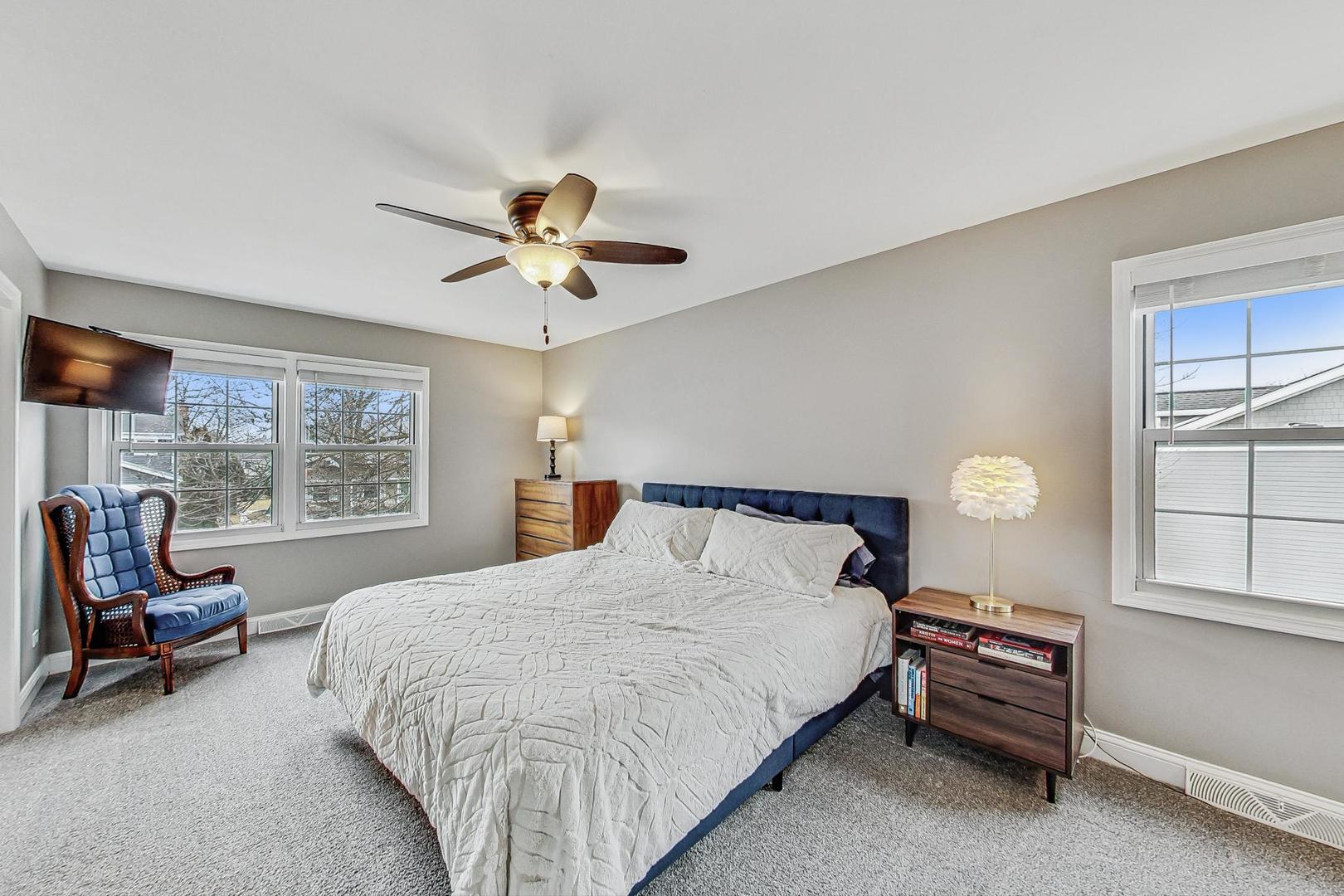 1345 East Bailey Road Naperville, IL 60565 - Photo 18 of 49 a bedroom with a bed and a chandelier