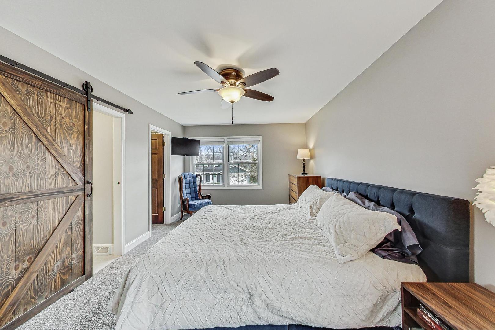 1345 East Bailey Road Naperville, IL 60565 - Photo 19 of 49 a bed sitting in a bedroom next to a window