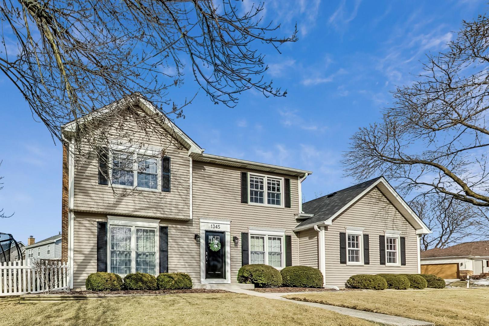 1345 East Bailey Road Naperville, IL 60565 - Photo 2 of 49 a front view of a house with a yard